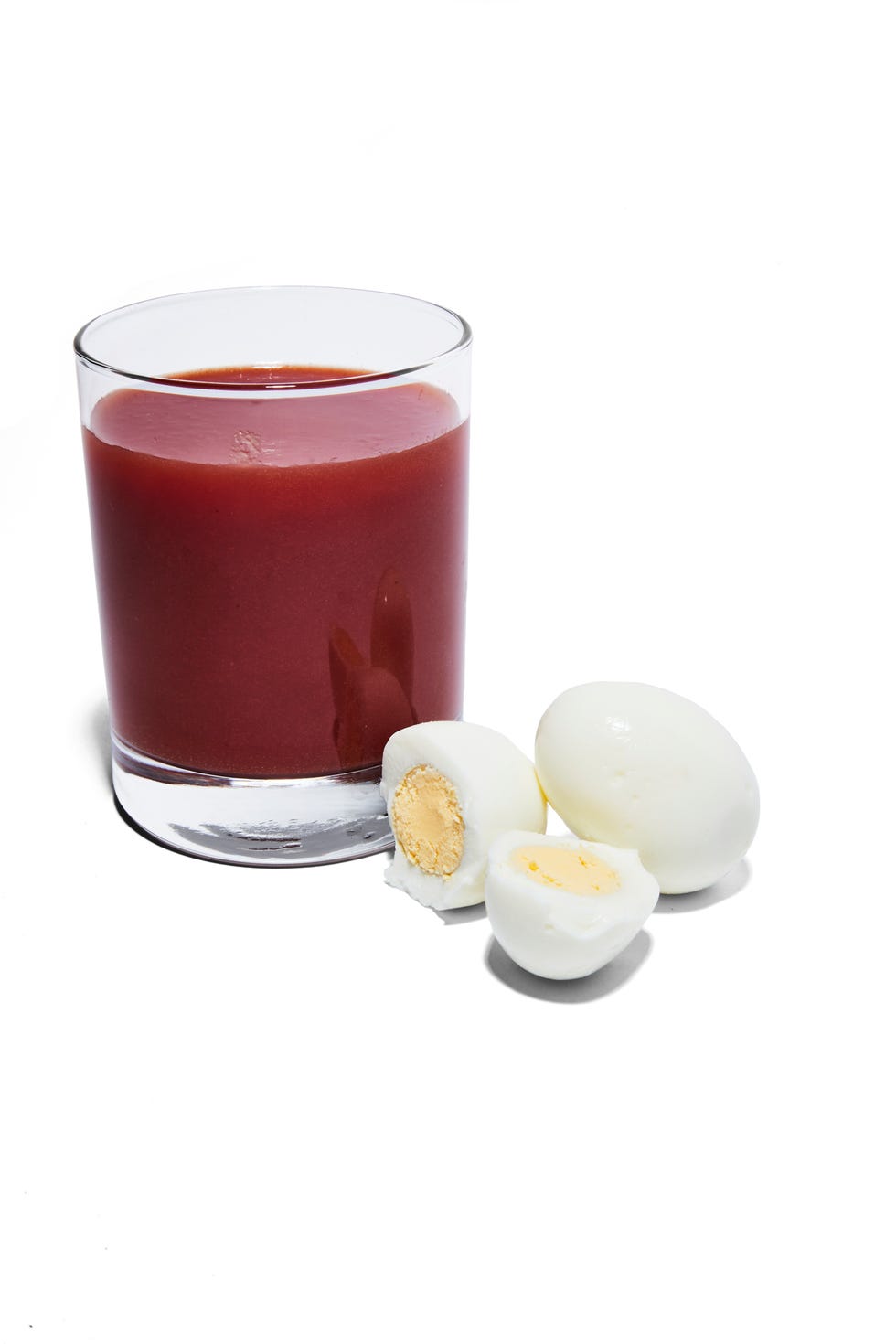 glass of tomato juice and hard boiled eggs