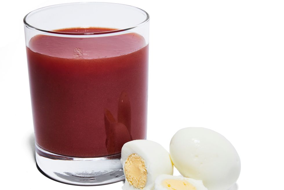 glass of tomato juice and hard boiled eggs