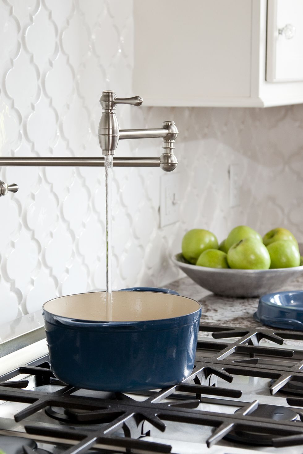 pot filler faucet on stove in kitchen