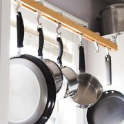 pans and pots hanging above kitchen sink