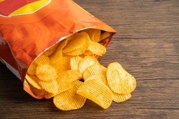 potato chips, delicious bbq seasoning spicy for crips, thin slice deep fried snack fast food in open bag