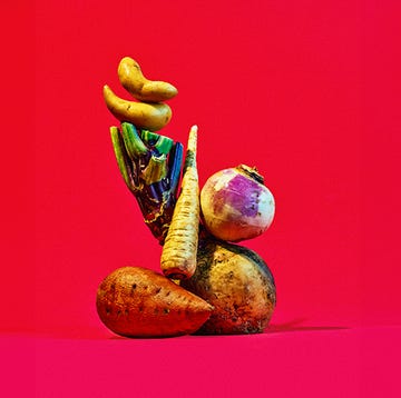 potato-extended a colorful arrangement of vegetables against a bright red background