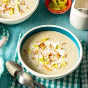 potato leek soup recipe with fried onion, yellow celery leaves, heavy cream