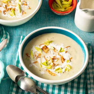 potato leek soup recipe with fried onion, yellow celery leaves, heavy cream