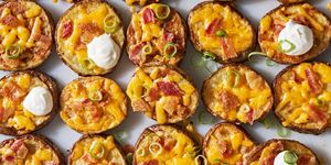circles of crispy potatoes with melted cheese, bacon and dollops of sour cream