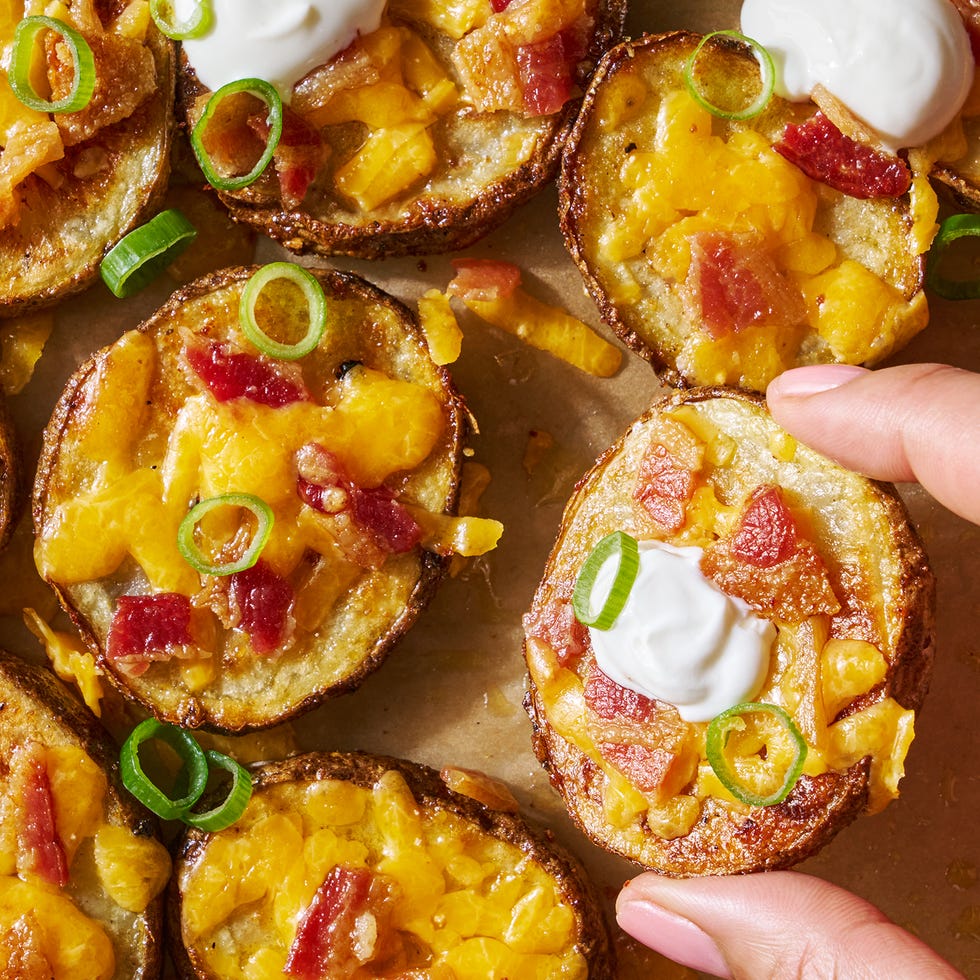 circles of crispy potatoes with melted cheese, bacon and dollops of sour cream