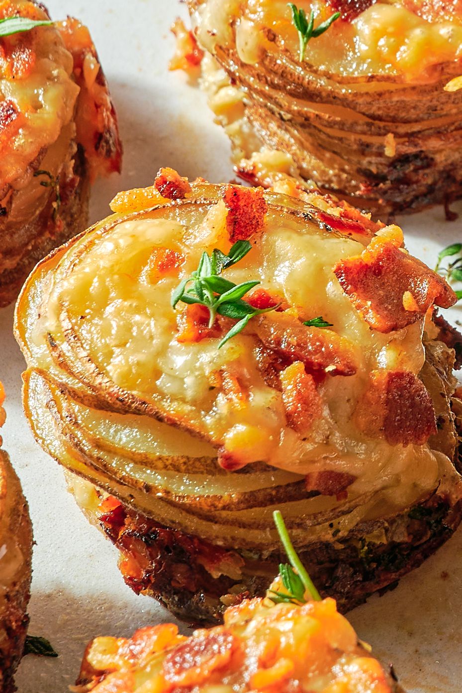 sliced potato stacks with melted cheese and bacon