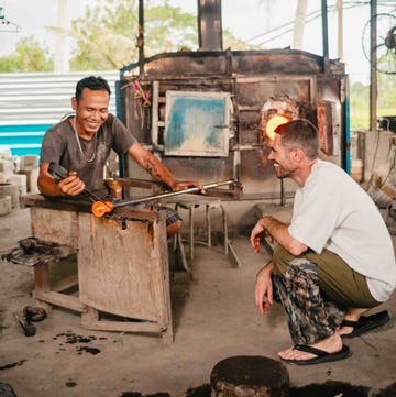 'Wasted' work in progress by Max Lamb two men crouching and blowing glass