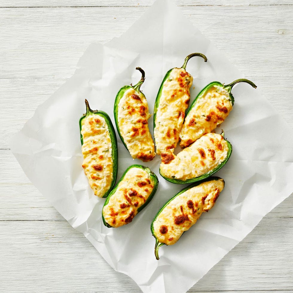 cheese stuffed jalapeños on parchment paper