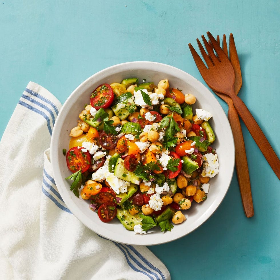 chickpea salad with smashed cucumbers in a white bowl