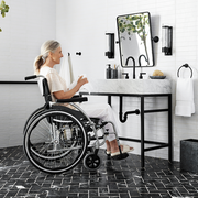 pottery barn accessible home collection, woman in wheelchair in bathroom
