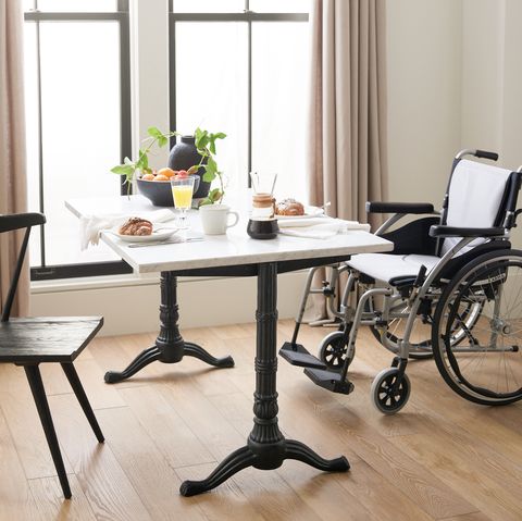 small rectangular table with one chair and a wheelchair