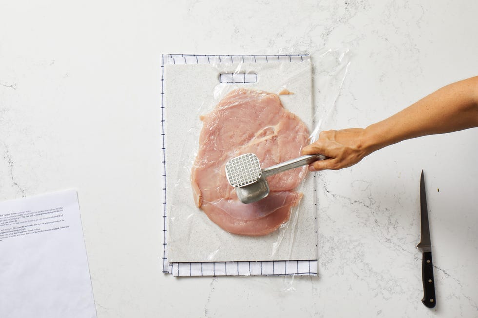 pounding turkey breast in plastic wrap