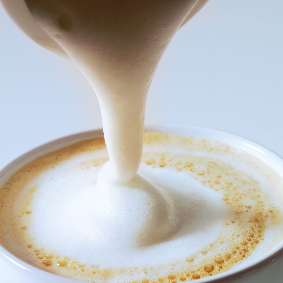 pouring cream on cappuccino