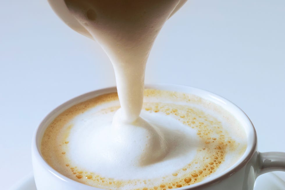 pouring cream on cappuccino