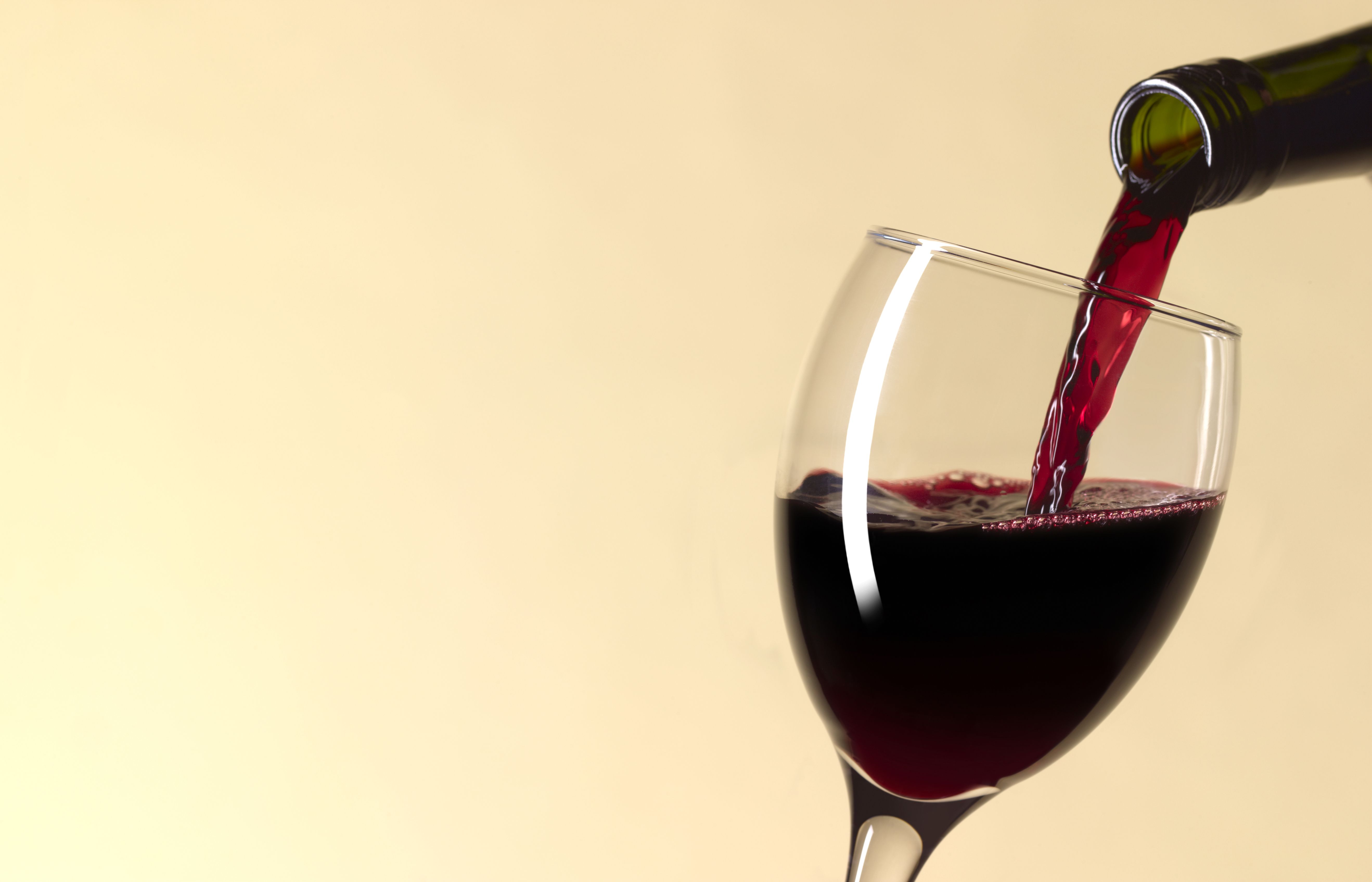 https://hips.hearstapps.com/hmg-prod/images/pouring-glass-of-red-wine-with-copy-space-royalty-free-image-1591389677.jpg