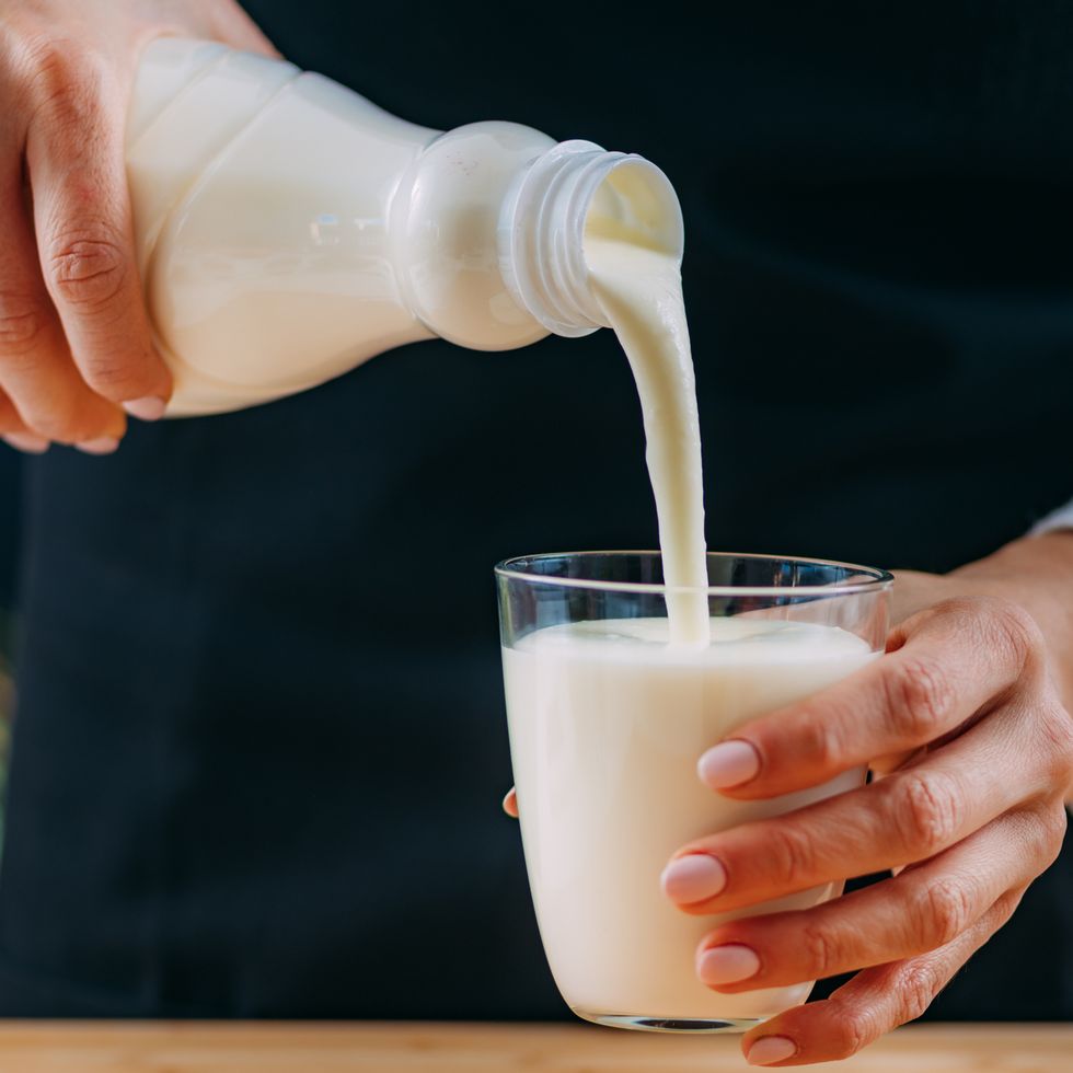pouring kefir into glass, a healthy fermented dairy superfood drink