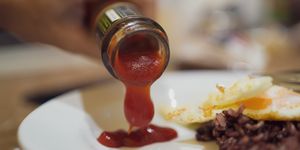 pouring ketchup into a dish