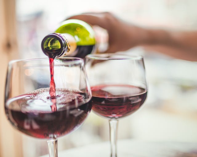 Pouring red wine in glasses