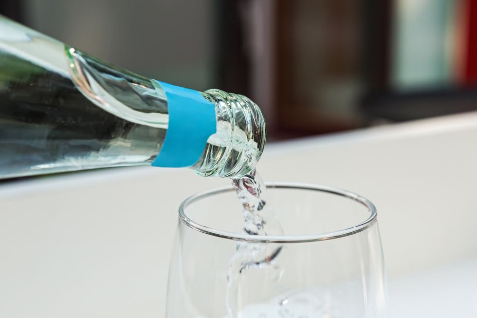 pouring sparkling water into a glass