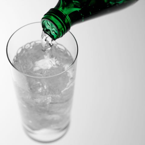 pouring sparkling water into glass