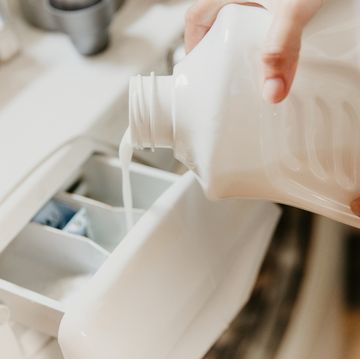 pouring washing liquid in washing machine