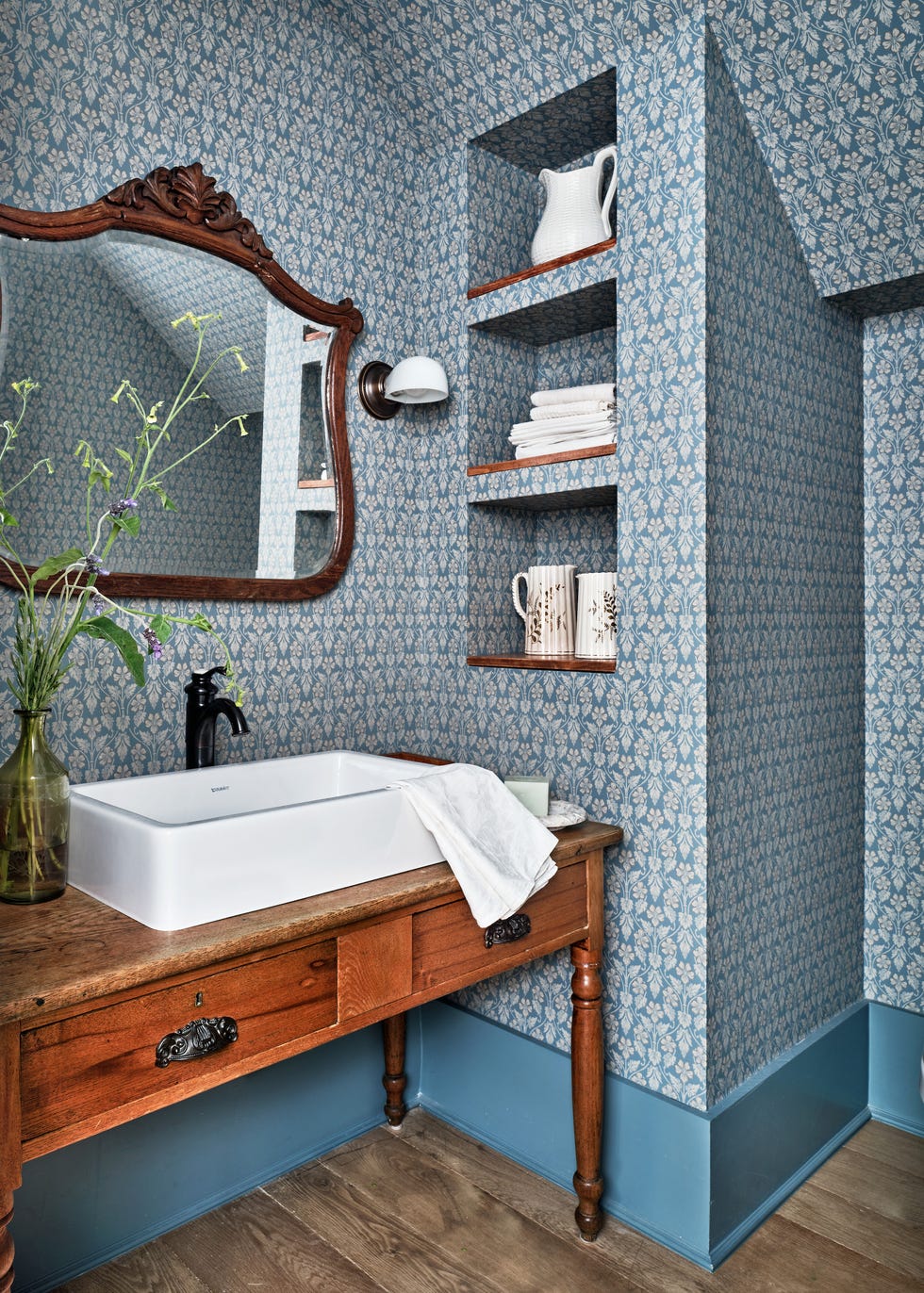 powder bath with antique table vanity and wallpaper