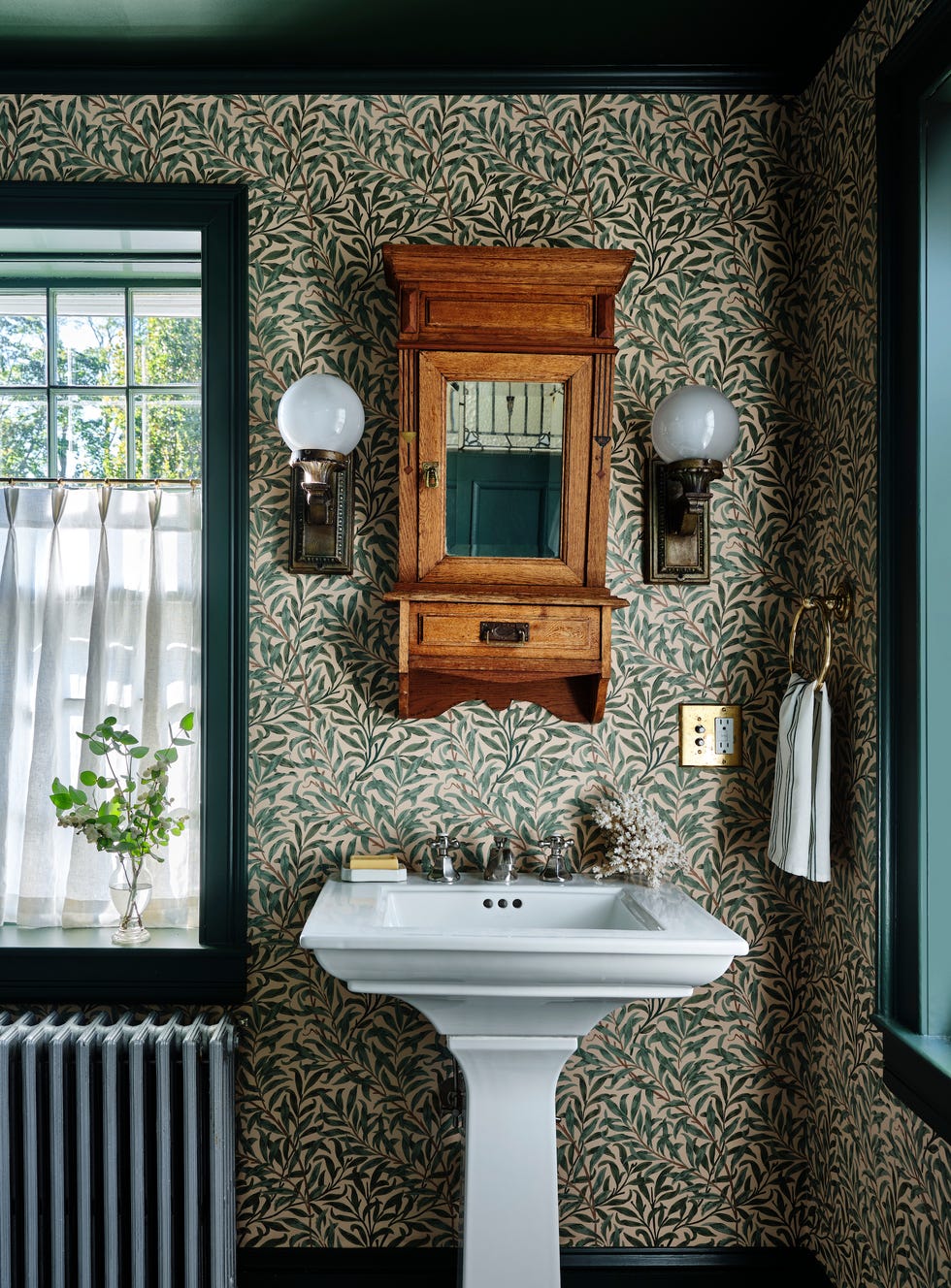 powder bathroom with green leaf wallpaper