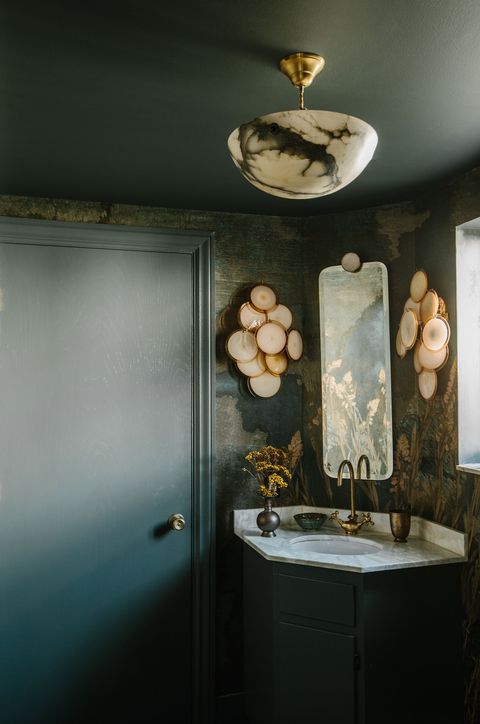 green powder room with brass