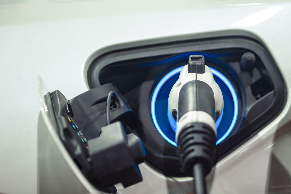 Power supply connect to electric vehicle for charge to the battery. Charging technology industry transport which are the futuristic of the Automobile. EV fuel Plug in hybrid car