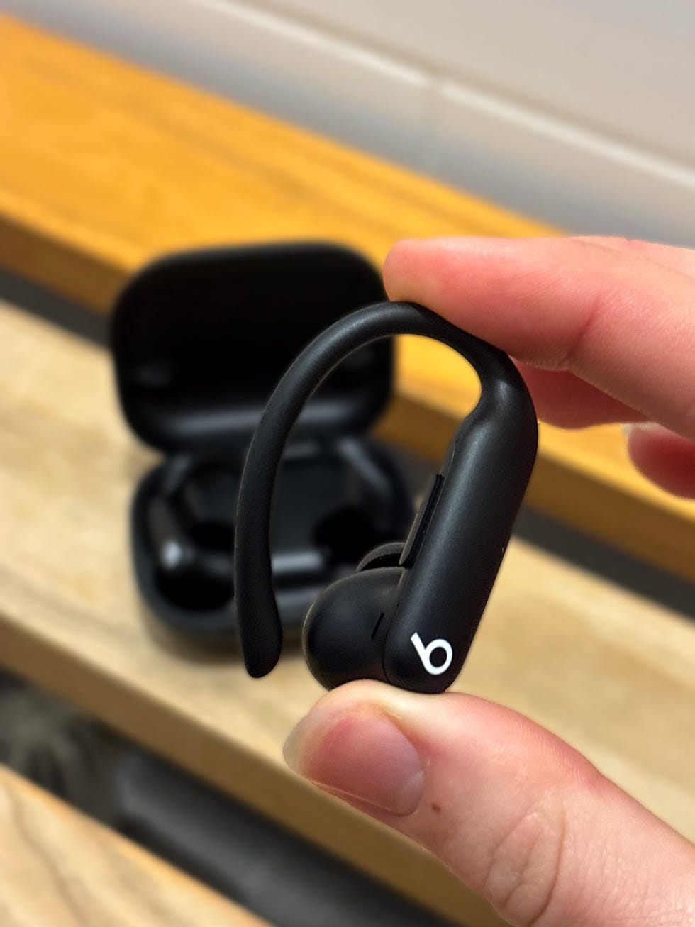 person holding an earphone in their hand