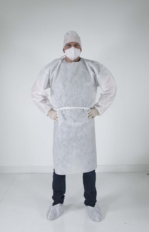 man standing in medical gear over clothes