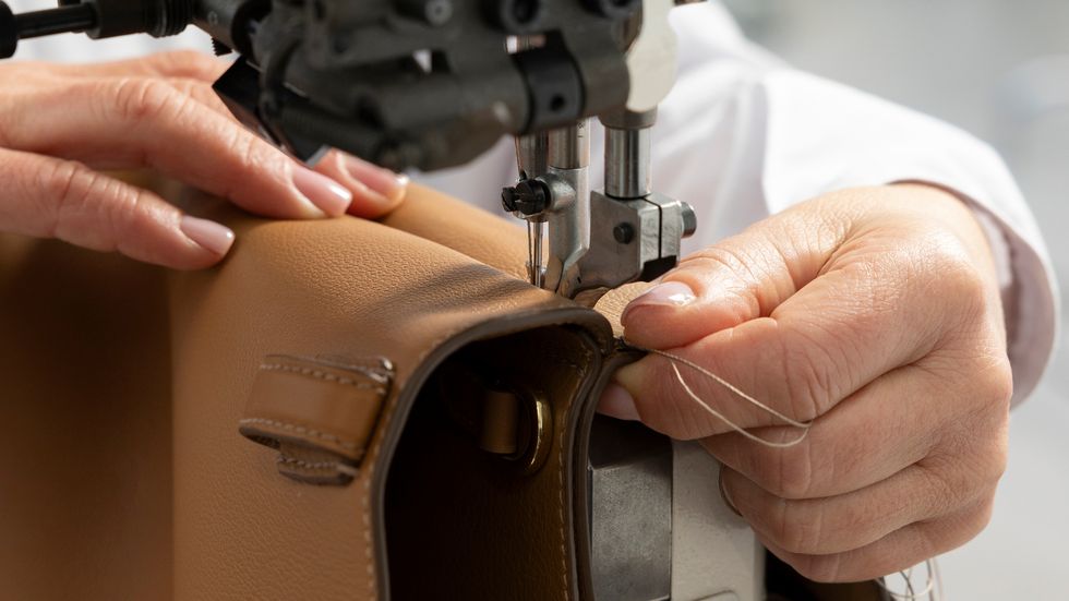 a person using a sewing machine