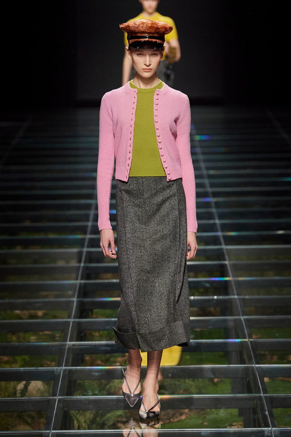 Fashion model showcasing a layered outfit on a runway
