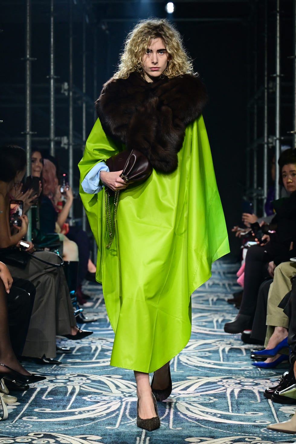 model walks the prada run way in chartreuse in milan fashion week