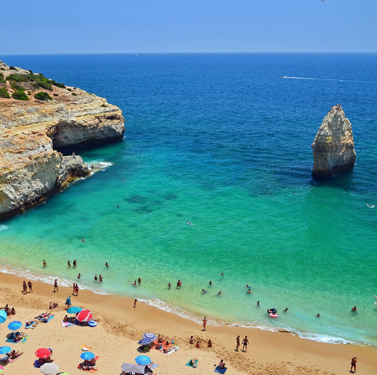 Praia do Carvalho, Portugal praia do carvalho, portugal beach with a jutting rock in the middle of the water