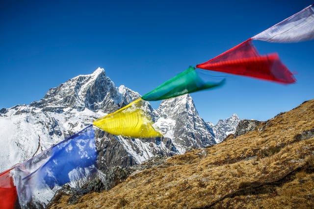 prayer flags in the wind along the trail to everest base camp, nepal