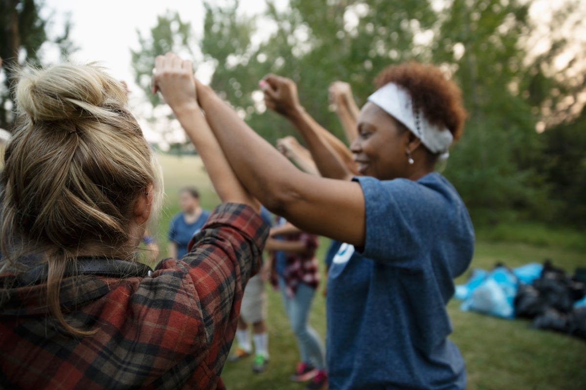 prayers for a friend group of friends holding hands above their heads in a circle