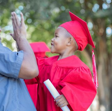 preschool graduate giving high five to dad