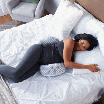 woman using boppy pregnancy pillows in bed