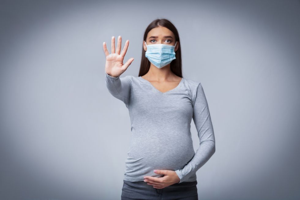 Pregnant Lady In Medical Face Mask Gesturing Stop In Studio