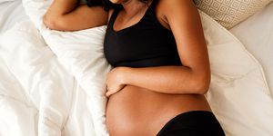 pregnant woman lying on a bed