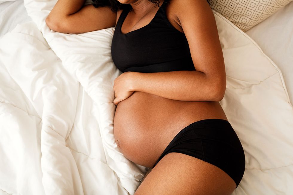 pregnant woman lying on a bed