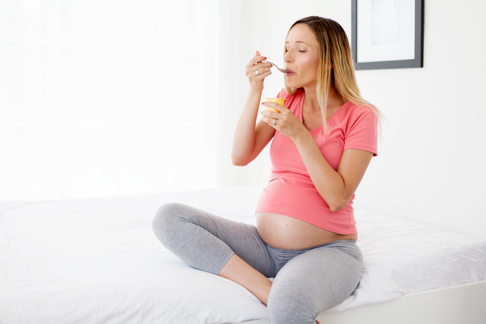 pregnant woman eating yogurt