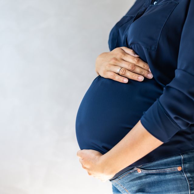 pregnant woman embracing her belly
