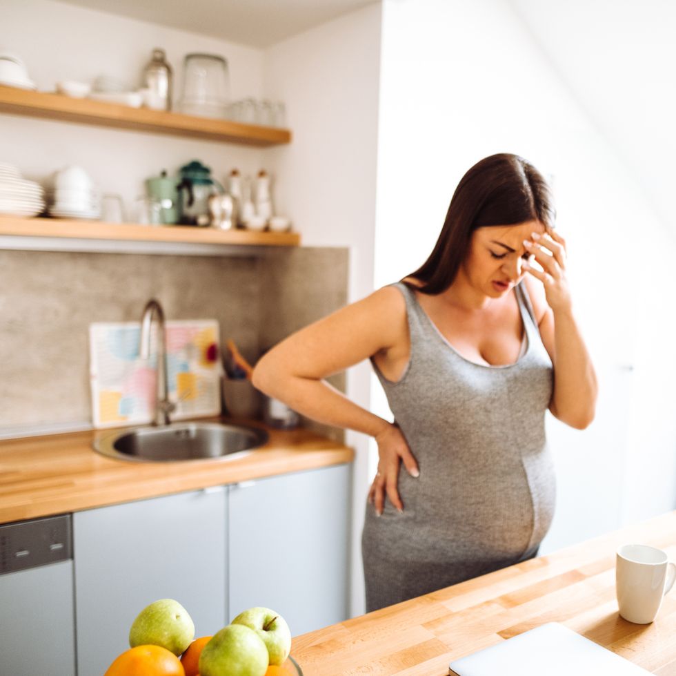 pregnant woman have a pain standing