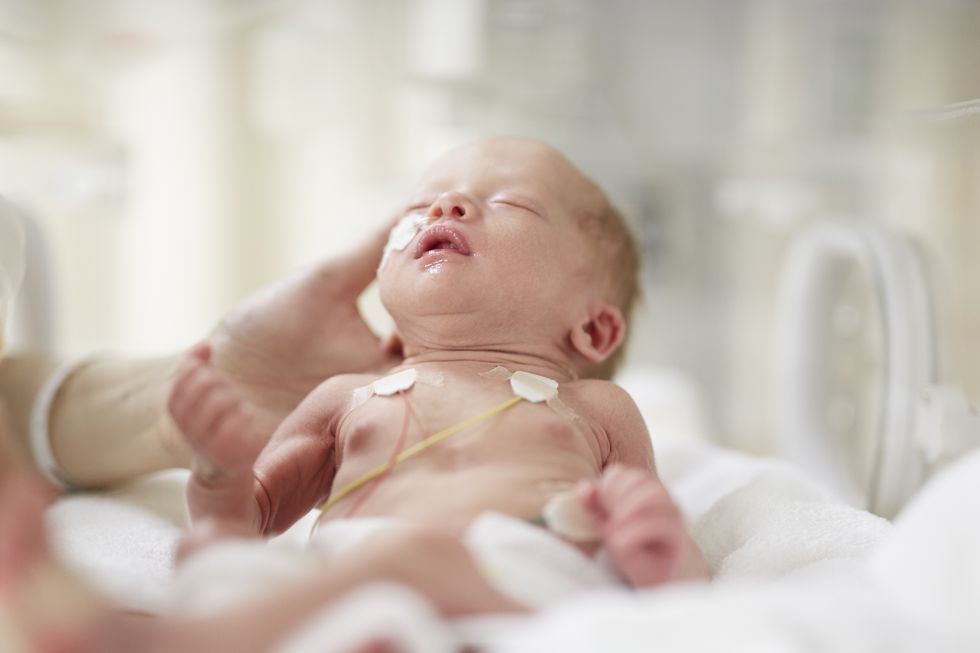 premature baby girl in incubator
