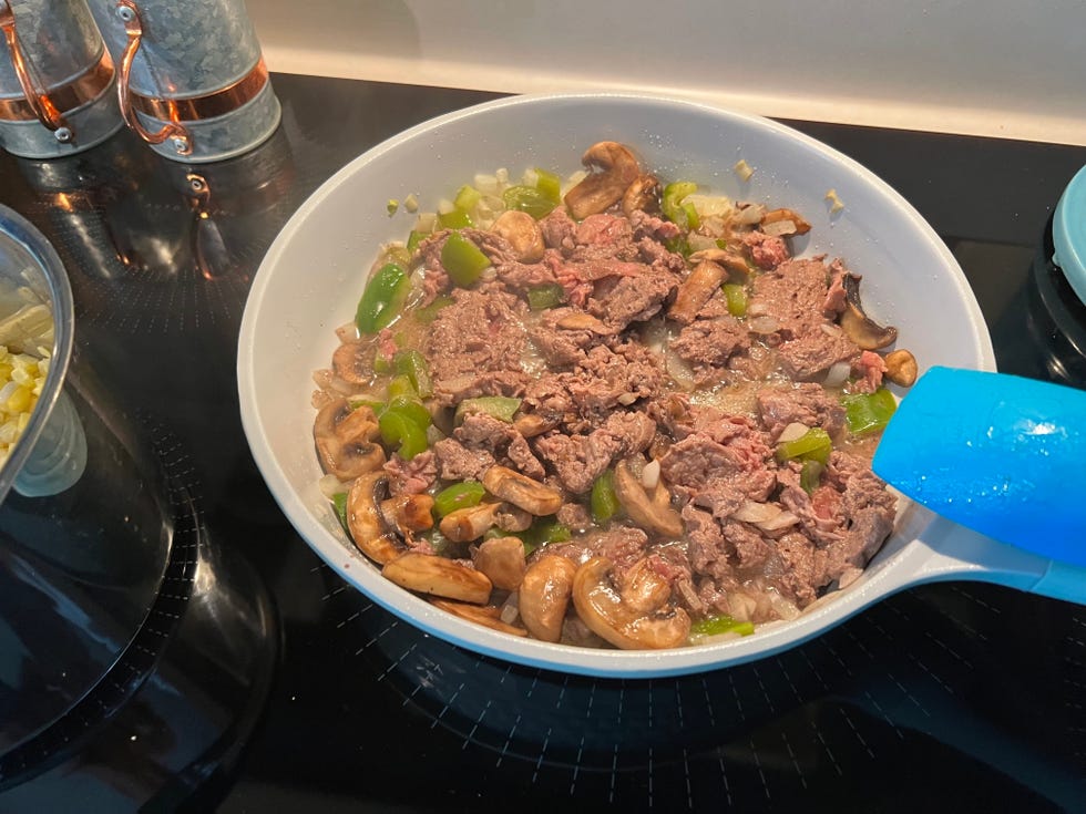 preparing homemade philly cheesesteak