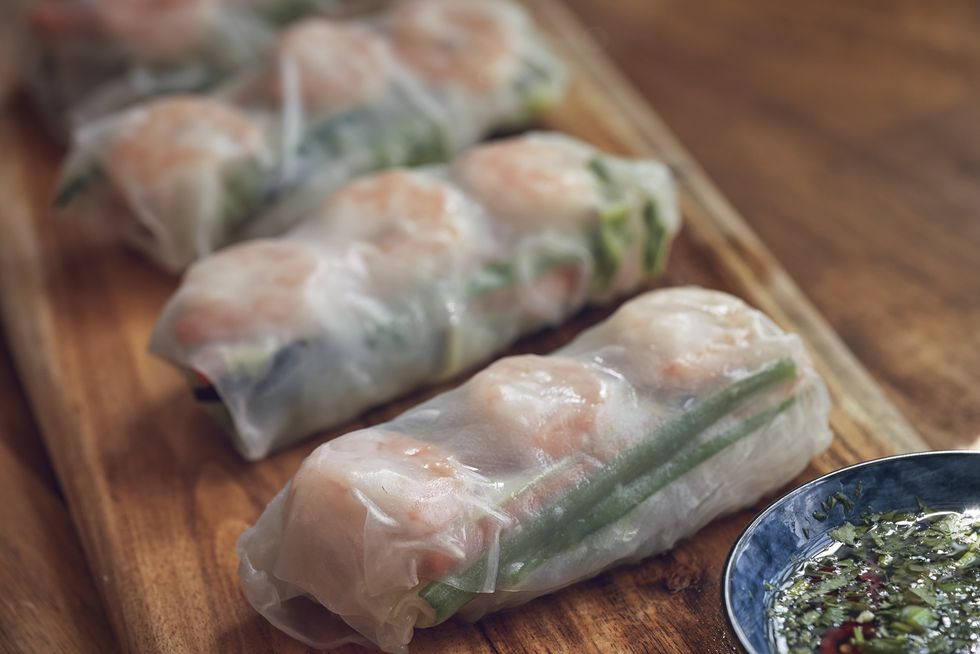 preparing spring rolls with vegetables and shrimps