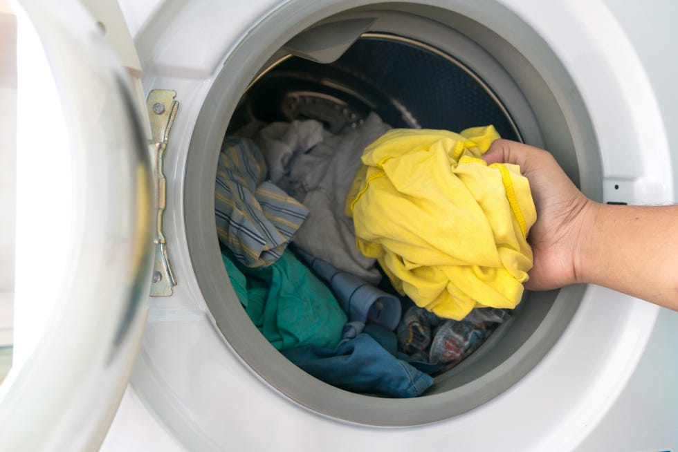 preparing the wash cycle washing machine, hands and clothes